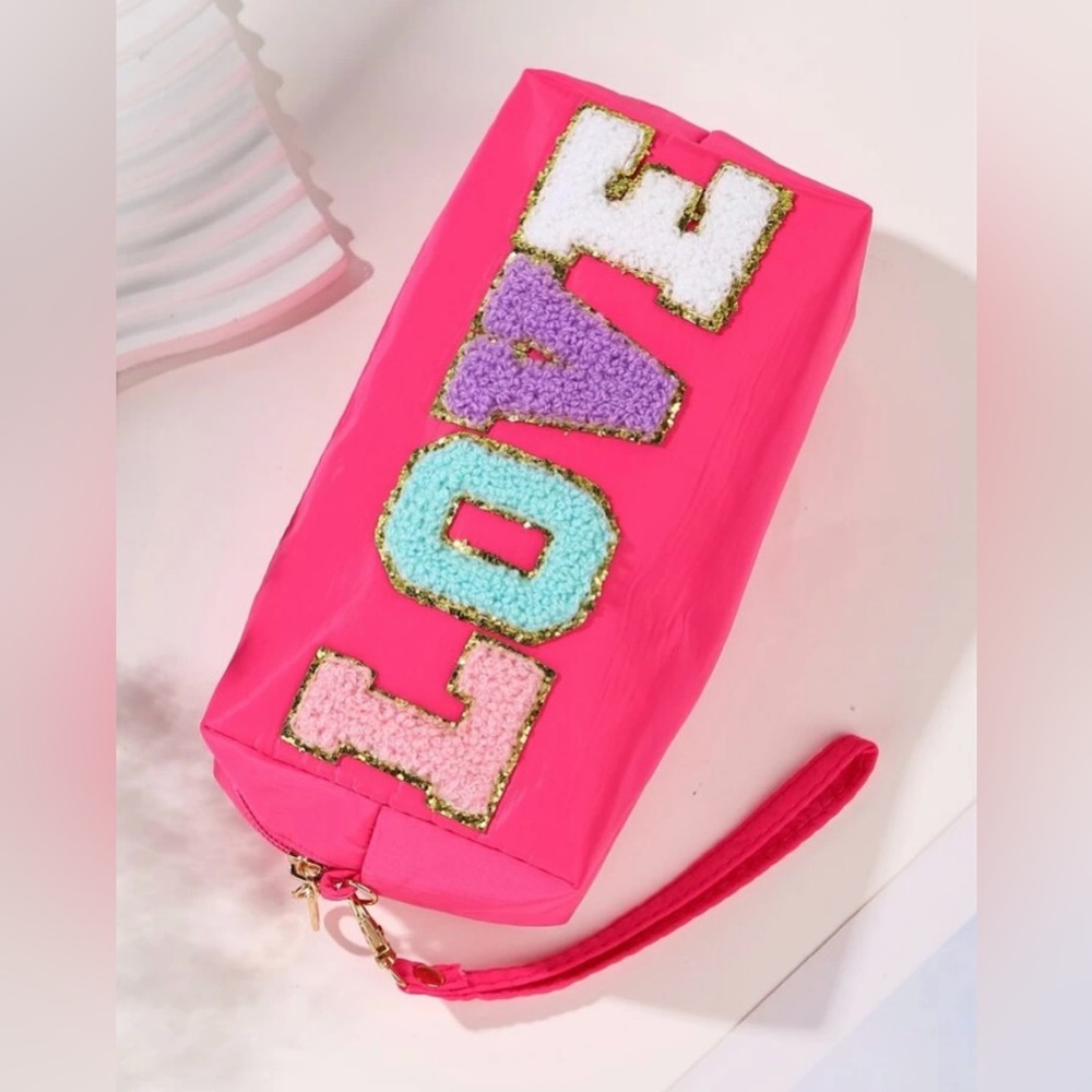 NWT LOVE makeup/wristlet makeup bag. Hot pink with Patch letters!